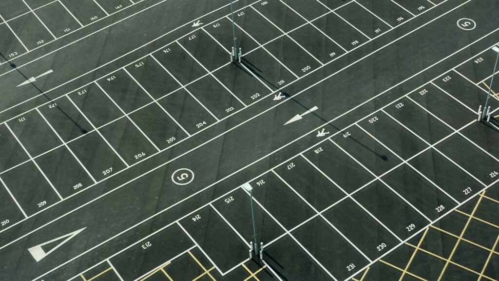 pexels photo 2220292 2220292 Aerial view of an empty parking lot with numbered spaces in London.