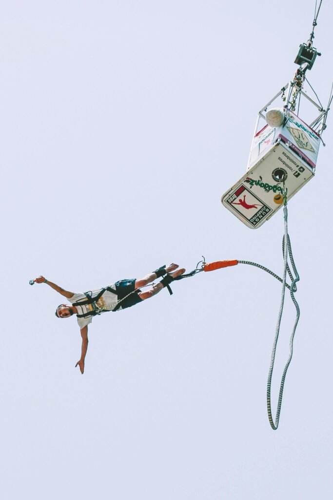 pexels photo 33255926 33255926 Experience the adrenaline rush of bungy jumping captured mid-air with clear blue sky backdrop.