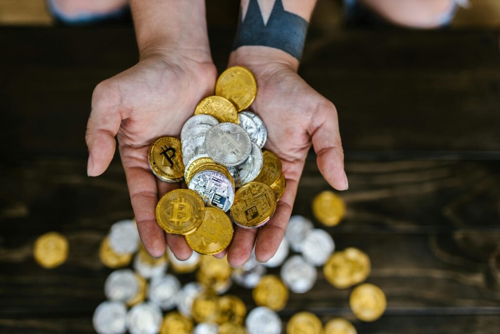 pexels photo 8370749 8370749 High angle of hands holding gold and silver cryptocurrency coins, symbolizing digital wealth.